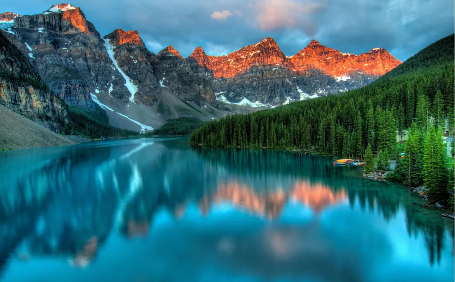 Sunlit mountains and a lake, inviting exploration of Allah’s creation